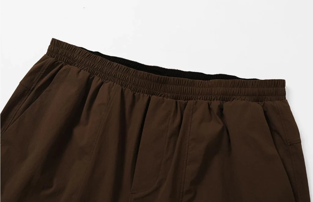 athletic shorts manufacturer dark brown athletic shorts hem and fabric detail