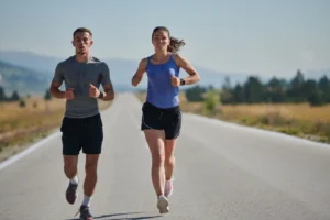 Men and women running outdoors wearing performance athletic shorts by professional athletic shorts manufacturers