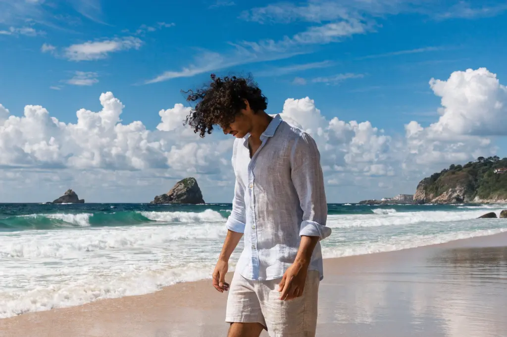 Man wearing casual shorts walking on a beach